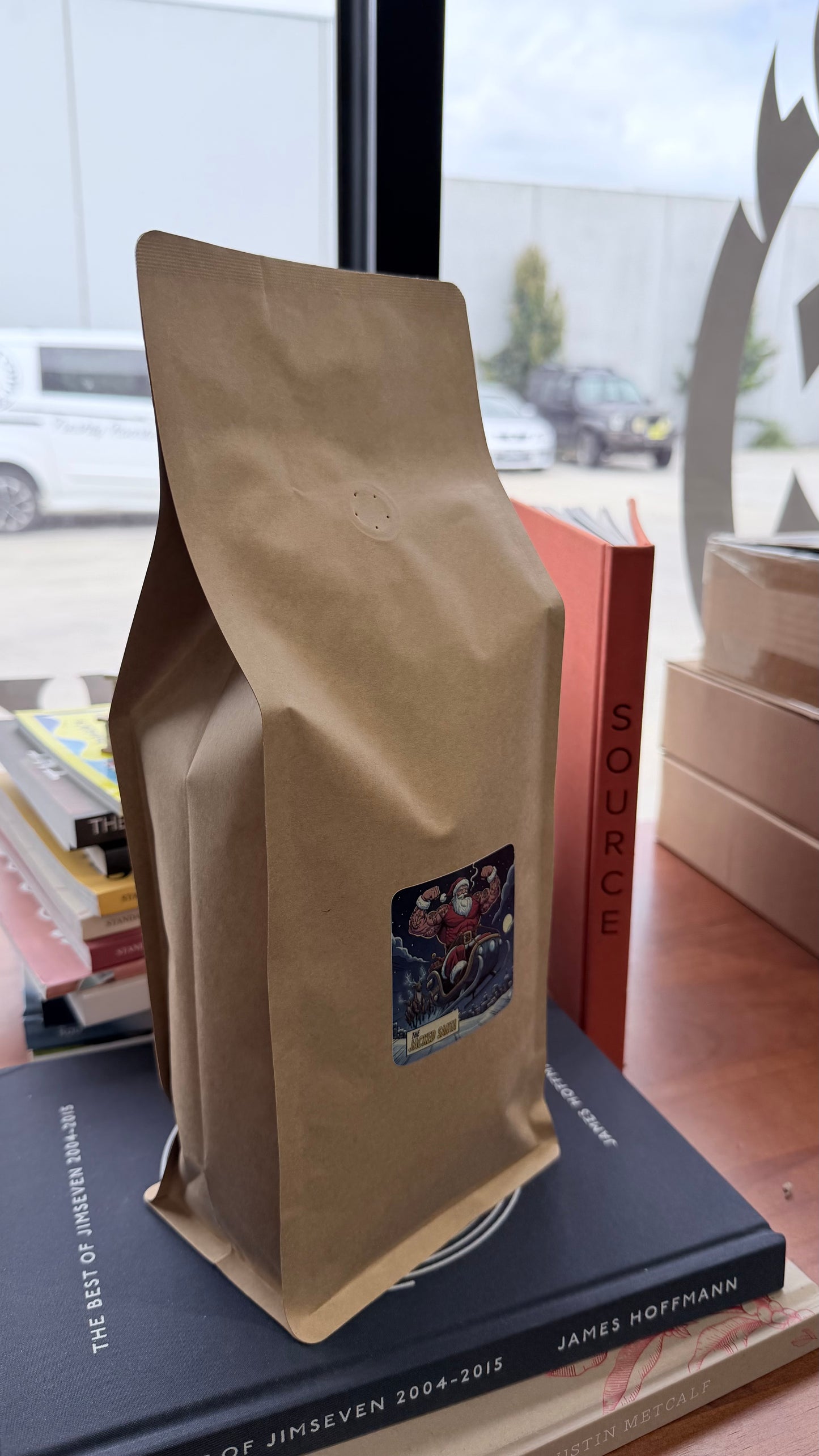 Kraft paper coffee bag with a label on top of a book