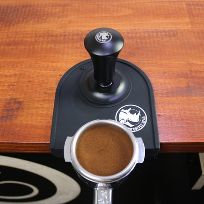 Rhino self-levelling tamper tamping a 58mm portafilter basket